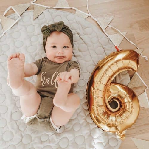 Baby in green sweater with green hair band