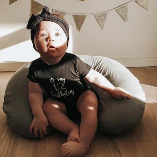 Baby with black sweater and black headband